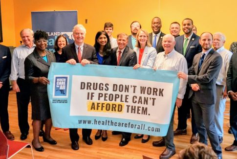 Democratic politicians, lobbyists and others pose Thursday with a Maryland Health Care for All sign. (The Daily Record/Johanna Alonso)