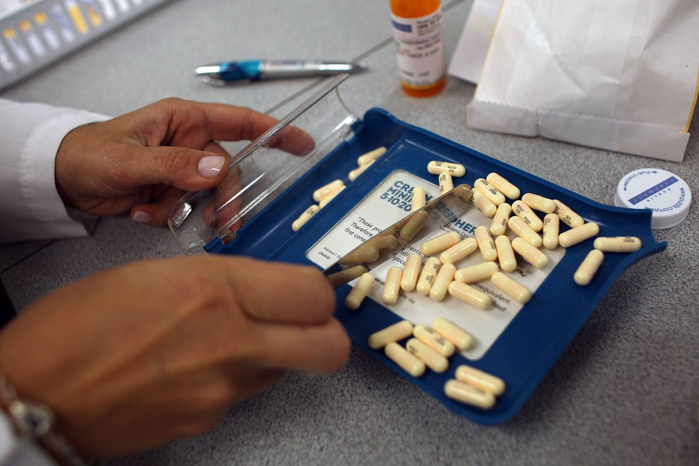 A pharmacist fills a prescription in this 2007 file photo.