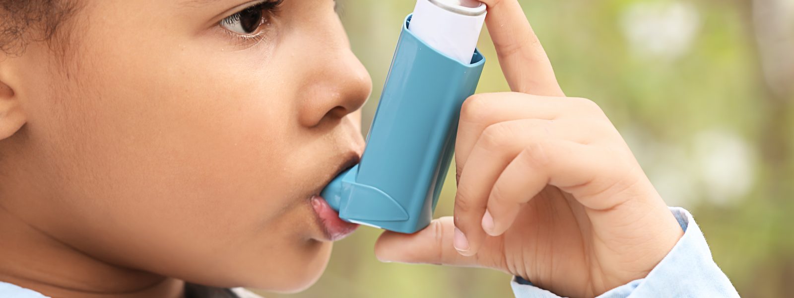 Child using inhaler outside