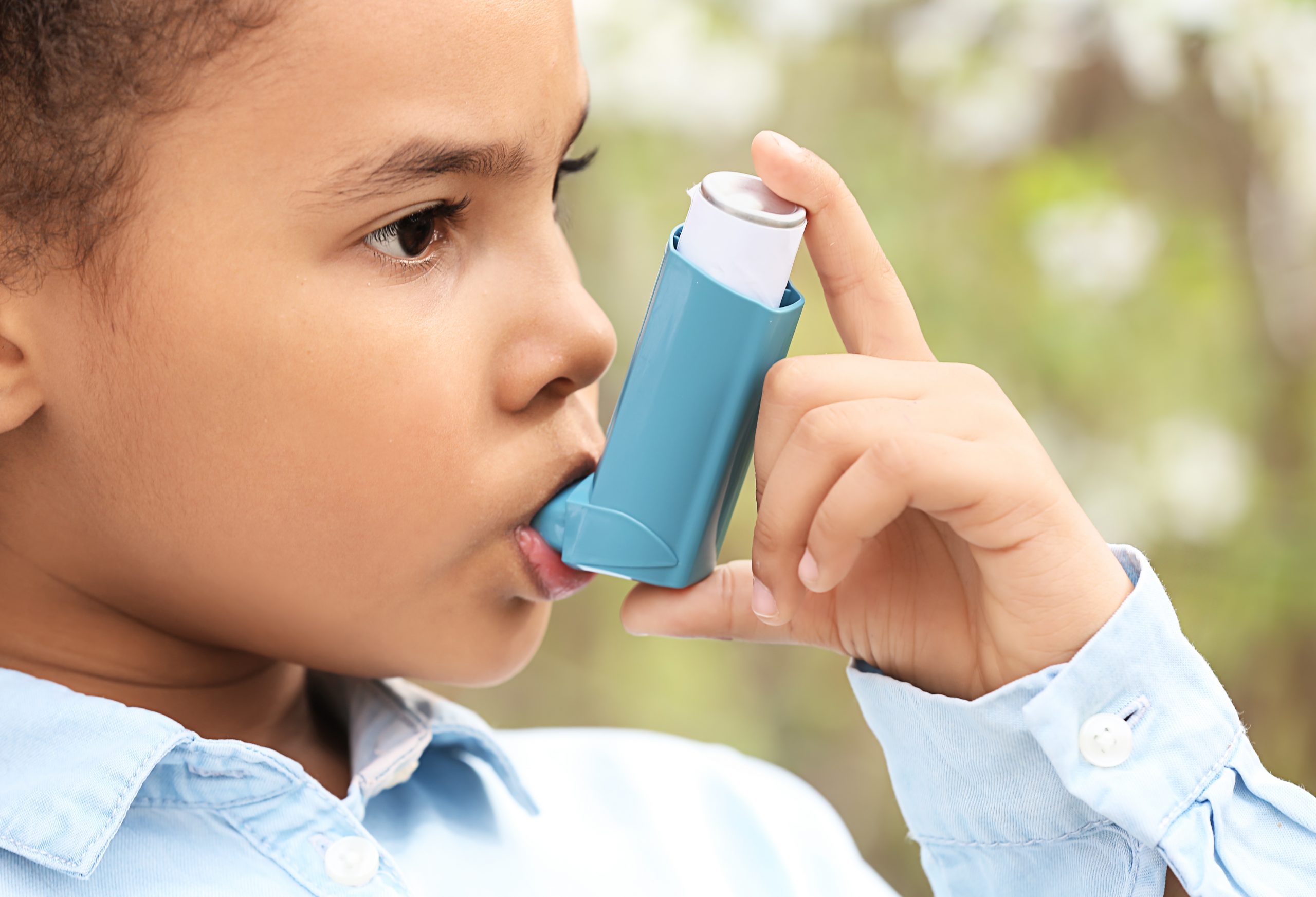 Child using inhaler outside