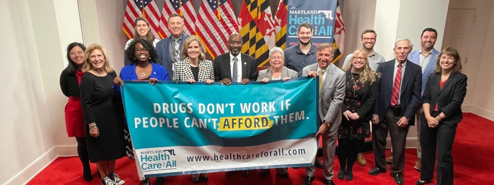 People holding banner that reads, "Drugs Dont Work if People Can't Afford Them."