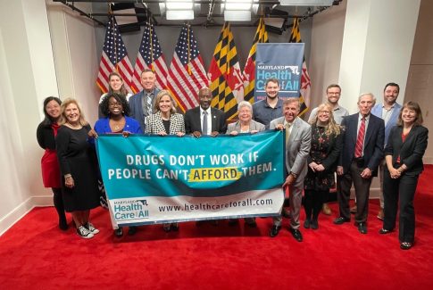 People holding banner that reads, "Drugs Dont Work if People Can't Afford Them."