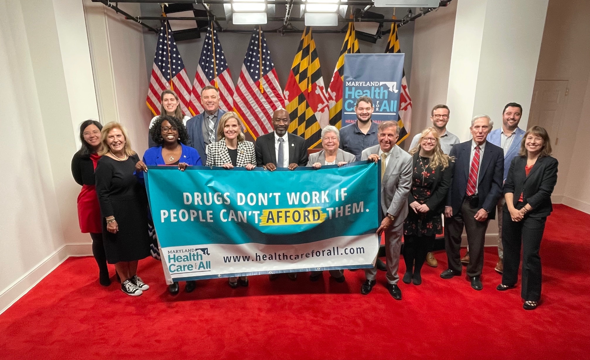 People holding banner that reads, "Drugs Dont Work if People Can't Afford Them."